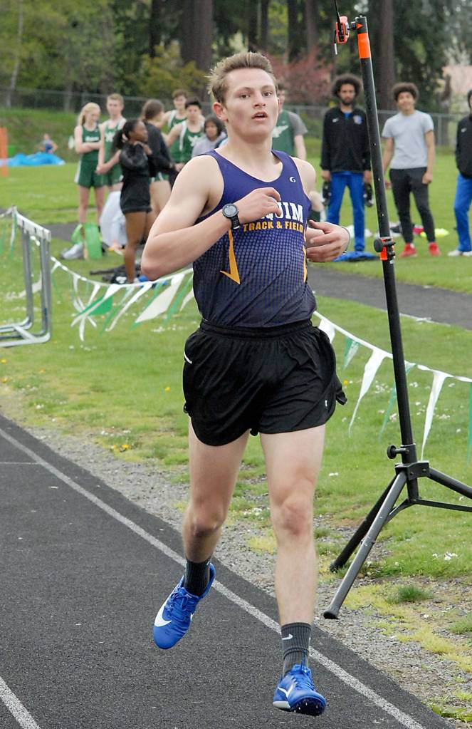 Keith Thorpe/Peninsula Daily News Sequims Murray Bingham crosses the finish line to take first in the boys 1,600-meter race on Thursday at Port Angeles High School.