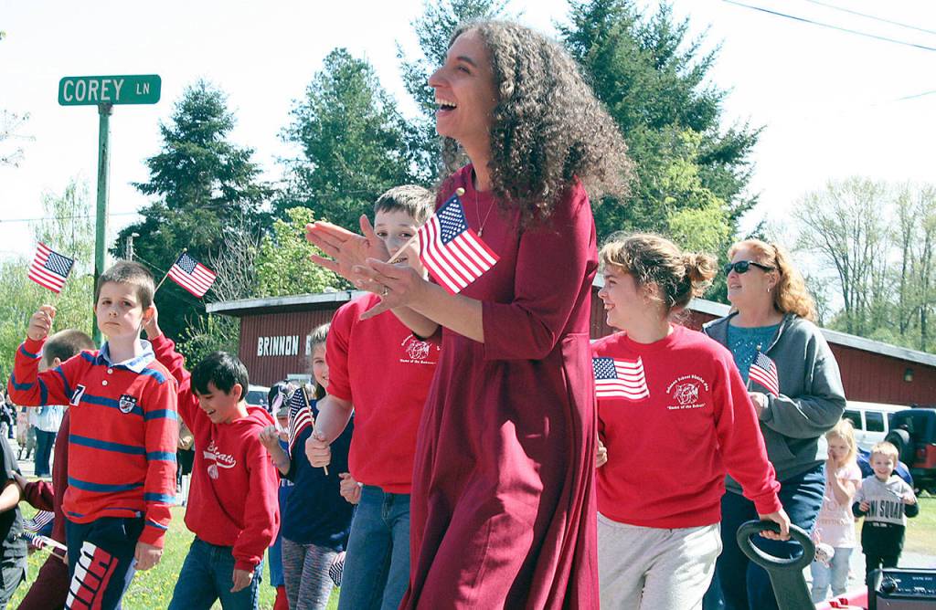 Teachers and students from Brinnon Schools laugh as they march from the start of the Loyalty Day Parade along Corey Street on Friday in Brinnon. (Brian McLean/Peninsula Daily News)