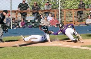 Wyatt Hall scores Port Angeles first run in a 3-2 comeback win over North Kitsap that clinched a repeat Olympic League title for the Roughriders. (Dave Logan/for Peninsula Daily News)