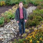 Joe Holtrop, Clallam Conservation District executive director, pictured in the rain garden at the Clallam County Courthouse, presents Rain Gardens and Runoff on Thursday in Port Angeles. (Amanda Rosenberg)