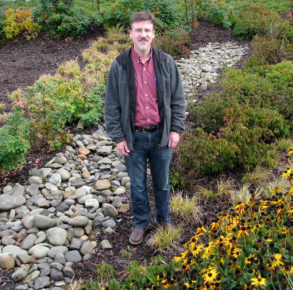Joe Holtrop, Clallam Conservation District executive director, pictured in the rain garden at the Clallam County Courthouse, presents Rain Gardens and Runoff on Thursday in Port Angeles. (Amanda Rosenberg)