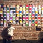 Adele Caemmerers Pantone Wall, one of the pieces in the pARTicipation shown at the Port Angeles Fine Arts Center, invites passers-by to select color cards from a big stack and add them to the wall grid wherever they like. Over time, the grid will fill up with colors, turning into a multi-hued, abstract creation.