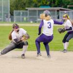 Steve Mullensky/for Peninsula Daily News Quilcenes Madison Coffey, left, guards second base and gets the out on Pope John Paul IIs Lauryn Johnson during a SeaTac League game in Quilcene on Thursday.