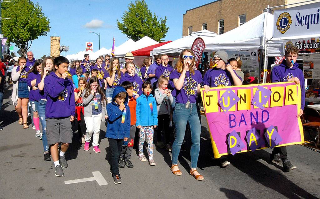 Youngsters march along with musicians from Sequim High School playing kazoos in the Kiddie Parade. (Keith Thorpe/Peninsula Daily News)