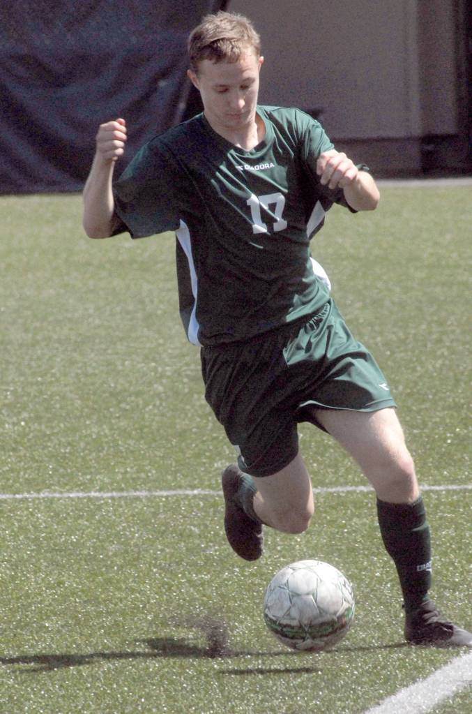 Keith Thorpe/Peninsula Daily News Austin Fischer of Port Angeles works to keep the ball in bounds during Saturdays game against Foster.