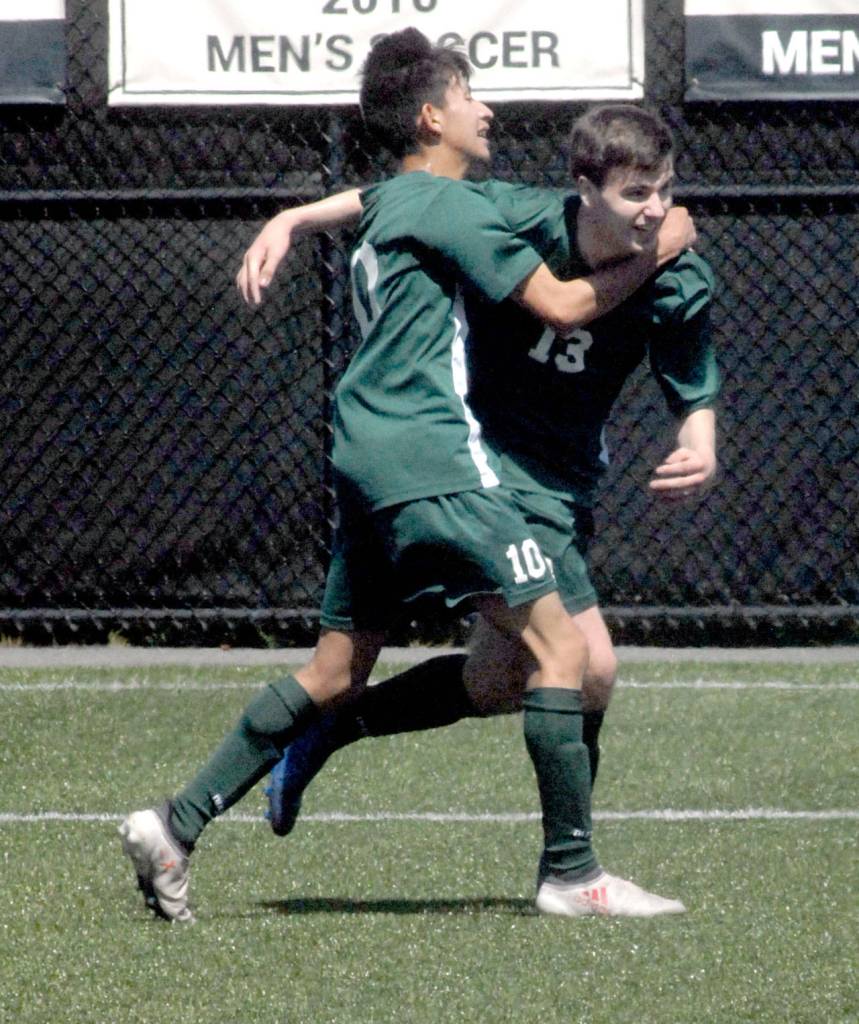 Keith Thorpe/Peninsula Daily News Port Angeles Stuart Methner, right, is congratulated by teammate Luis Galvan after Methner scored a goal against Foster in the first half at Peninsula College in Port Angeles.
