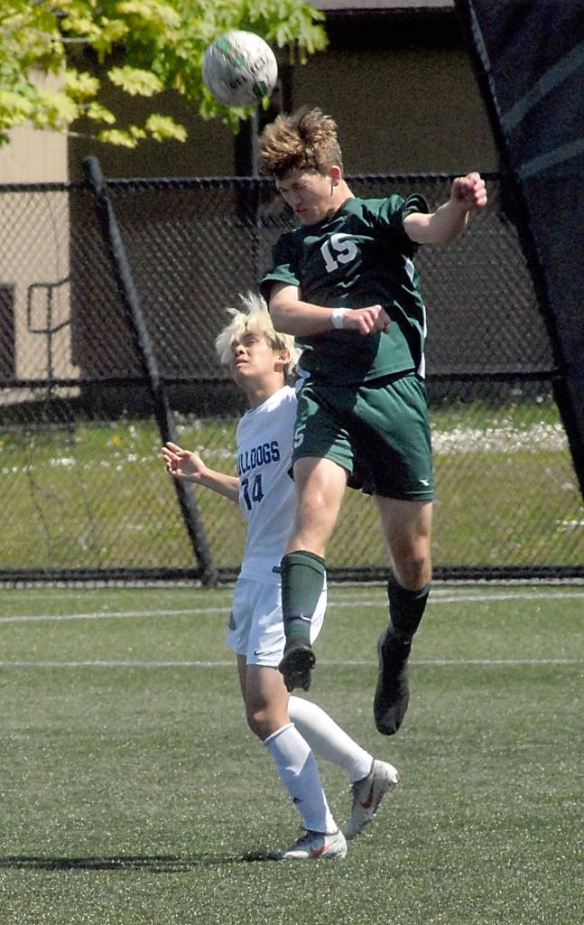 <strong>Keith Thorpe</strong>/Peninsula Daily News                                Port Angeles Sean Rankin takes a header over Fosters John Naw Sut on Saturday.