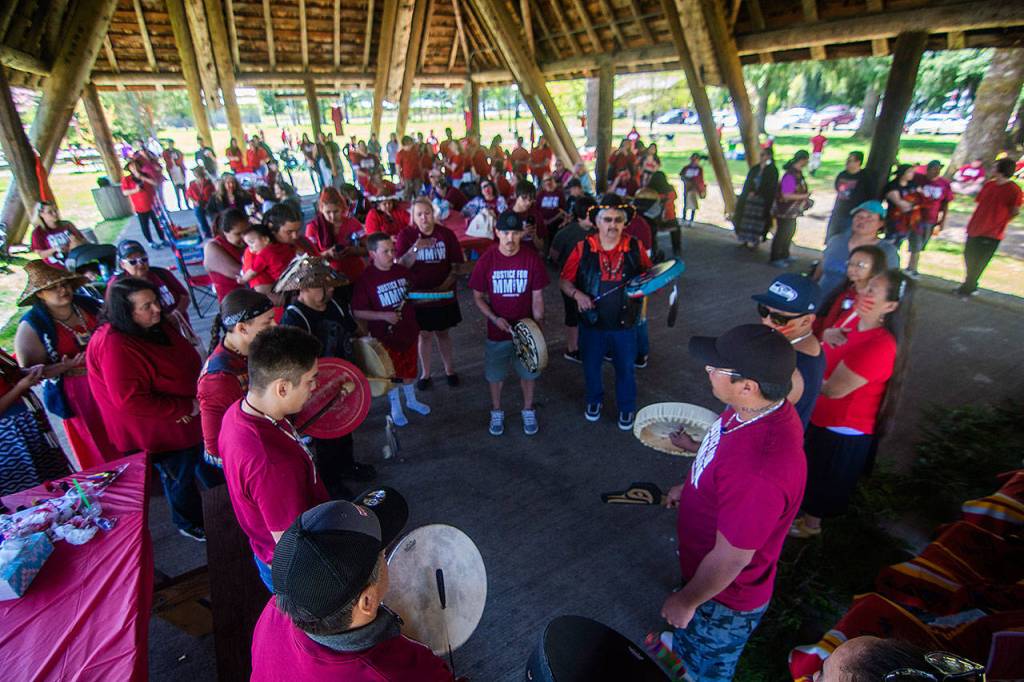 Tribal members drum at the march Sunday. (Jesse Major/Peninsula Daily News)