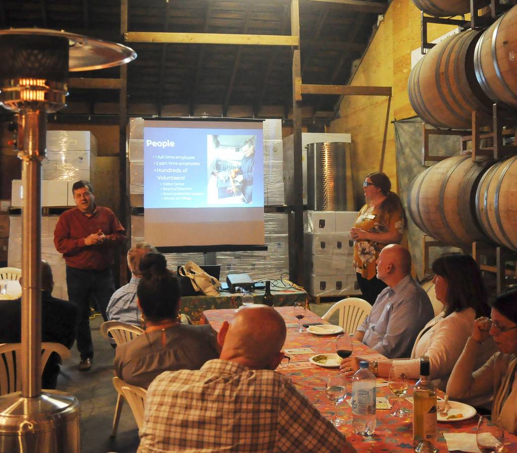 Mark Abshire and Anji Scalf, directors of the Port Angeles and Sequim chambers of commerce, speak with chamber members at Olympic Cellars Winery on Monday. (Michael Dashiell/Olympic Peninsula News Group)