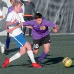Keith Thorpe/Peninsula Daily News Sequims Mathys Tanche, right, squeezes past Washingtons Iaen Ellis in the first half of Tuesdays playoff game against Washington.