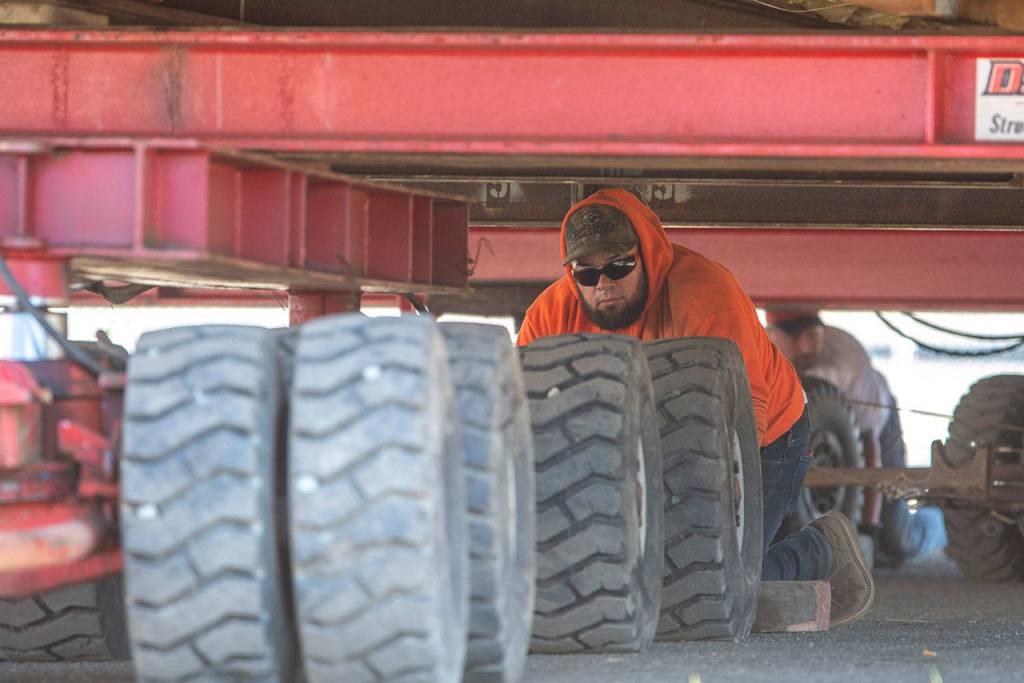 Crews work underneath the Horizon Center as it prepares to move to its new home at 223 E. Eighth Street on Thursday. (Jesse Major/Peninsula Daily News)