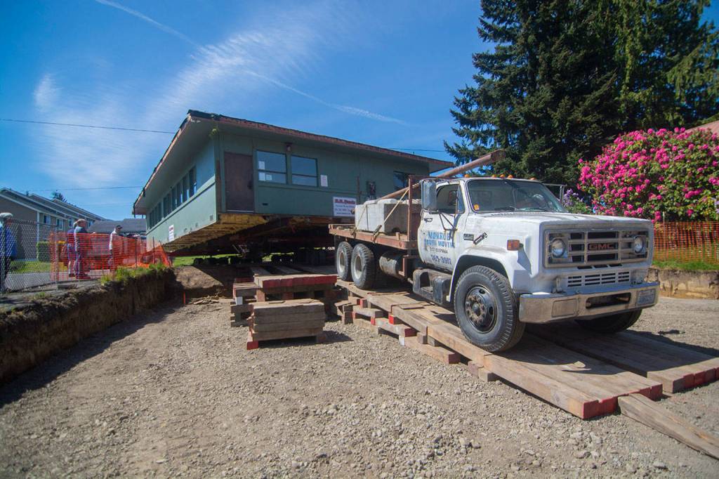 Peninsula Behavioral Healths Horizon Center is driven onto its new home at 223 E. Eighth Street on Thursday. (Jesse Major/Peninsula Daily News)