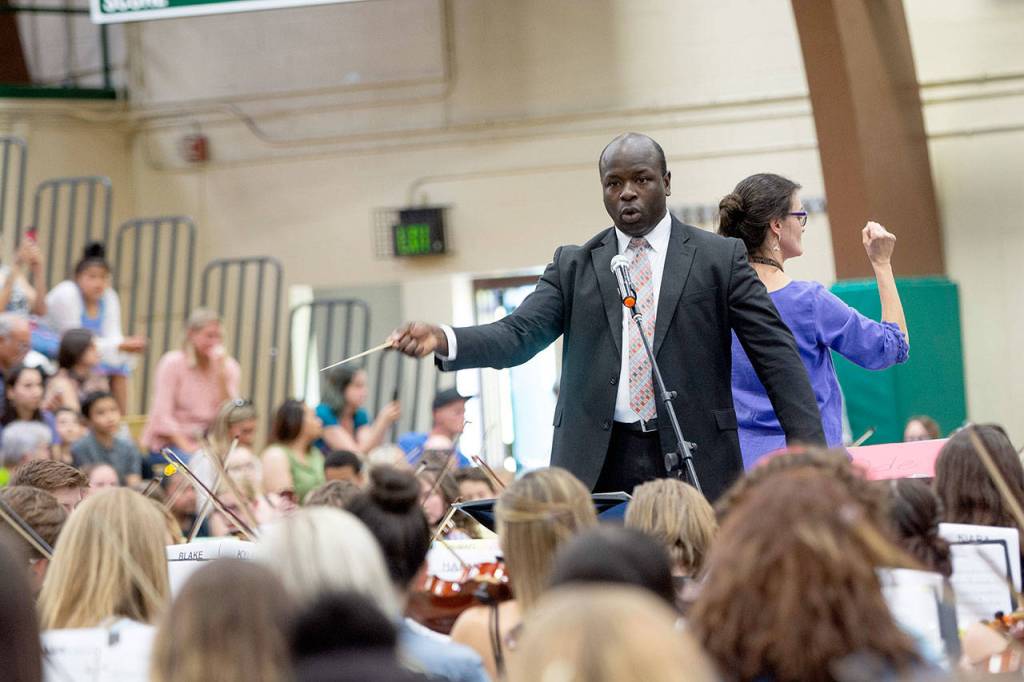 Port Angeles High School orchestra teacher James Ray conducts the opening fanfare at the 43rd annual All-City String Review. (Jesse Major/Peninsula Daily News)