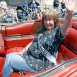Sequim Irrigation Festival parade Grand Marshal Jaye Moore, retired director of the Northwest Raptor and Wildlife Center, waves to the crowd on Saturday. (Keith Thorpe/Peninsula Daily News)