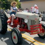 Kay Emmeret drives a vintage 1951 Ford tractor as part of a parade entry for Lonnie Love. (Keith Thorpe/Peninsula Daily News)