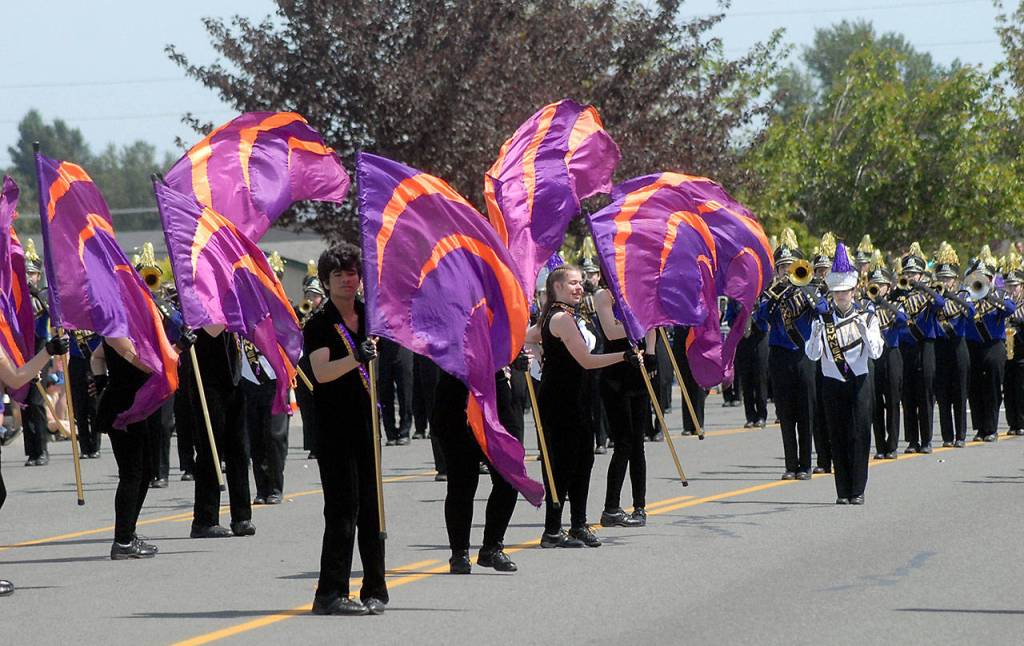 A flag team from Sumner High School leads the Sumner schools marching band. (Keith Thorpe/Peninsula Daily News)