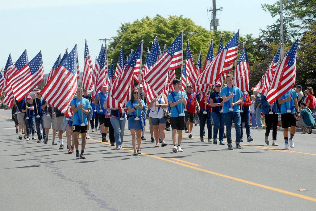 A forest of American flags highlight a parade entry for the Rotary International Neighborhood Flag Display project. (Keith Thorpe/Peninsula Daily News)