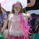 Eight-year-old Lily Arrington of Sequim takes delight in watching Saturdays parade. (Keith Thorpe/Peninsula Daily News)