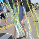 Alicia Disinski marches with an umbrella trailing streamers with a parade entry for Sequim Girl Scouts. (Keith Thorpe/Peninsula Daily News)