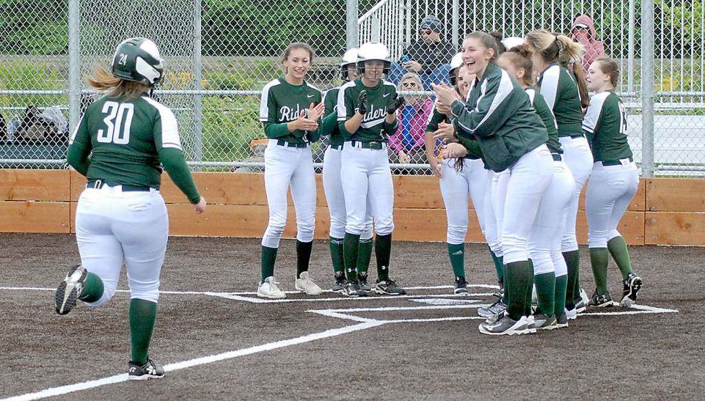 Keith Thorpe/Peninsula Daily News Madilyn Roening approaches home plate as her teammates wait to congratulate her after hitting a three-run homer in the fifth inning against Sequim.