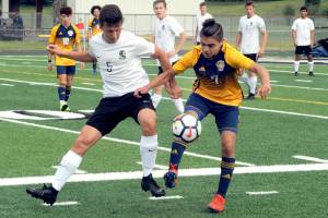 <strong>Lonnie Archibald</strong>/Peninsula Daily News                                Forks Hugo Sandoval, right, controls the ball against Klahowyas Logan Brunson during Tuesdays Class 1A state soccer tournament game at Spartan Stadium.