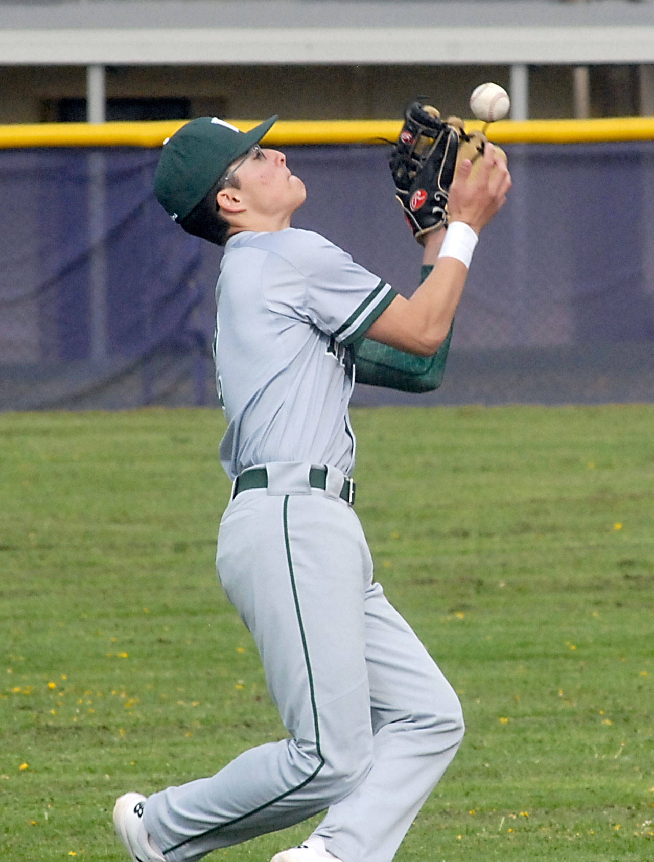 Keith Thorpe/Peninsula Daily News Port Angeles Gavin Guerrero catches a pop fly during a game against Sequim in April.