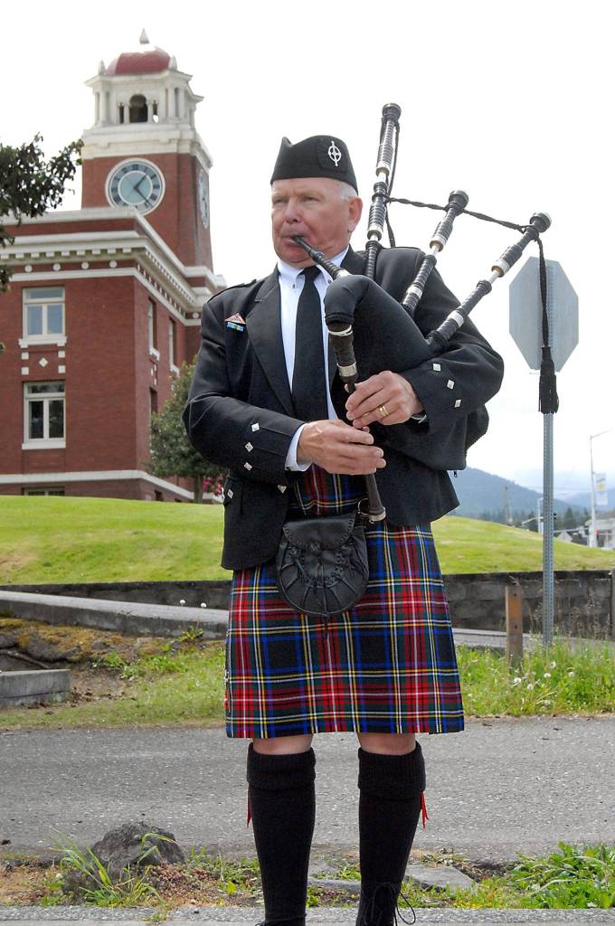 Dr. Tom McCurdy plays bagpipes at the begging of Fridays ceremony honoring fallen law enforcement officers. (Keith Thorpe/Peninsula Daily News)