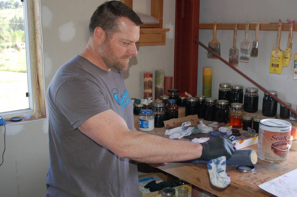 Gary White applies the dye to a Tsunami Bat. Conor Dowley/Olympic Peninsula News Group.