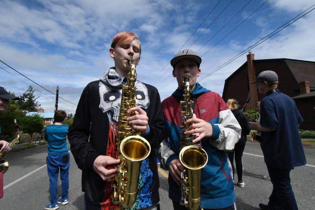 Chimacum Middle School band members Laine Martin, left, and Yeshiah Olson-Wailand, both in sixth grade, practice their alto saxophones just prior to the Rhody Kiddie Parade. (Jeannie McMacken/Peninsula Daily News)
