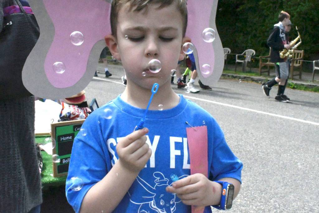 Masquerading as an elephant for the Rhody Kiddie Parade, Leland Lammers, 5, of Port Townsend passed the time before before the Kiddie Parade began blowing bubbles. He was part of the Cedar Brook Early Learning Center entry. (Jeannie McMacken/Peninsula Daily News)
