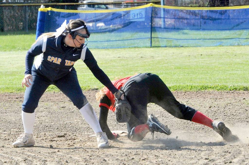 Lonnie Archibald/for Peninsula Daily News Forks shortstop Julia Lausche applies the tag to a baserunner during a game earlier this season.