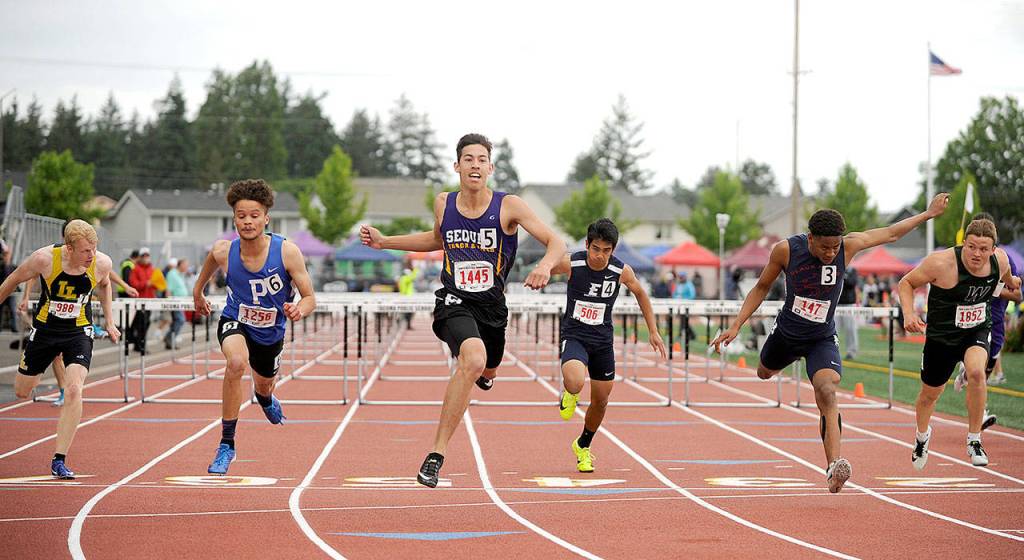 Sequims Riley Martin, center, finishes second in the 110-meter hurdles by 0.001 of a second at the state 2A Track and Field Championships. (Michael Dashiell/Olympic Peninsula News Group)