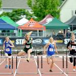 Port Angeles Millie Long, center, wins her heat in the 100-meter hurdles on Thursday. Long went on to win the state championship in the 300-meter hurdles on Saturday. (Michael Dashiell/Olympic Peninsula News Group)