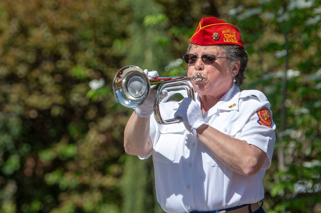 Jay McFarland, of the Mount Olympus Detachment of the Marine Corps League, performs taps at the Captain Joseph House memorial service Sunday. (Jesse Major/Peninsula Daily News)