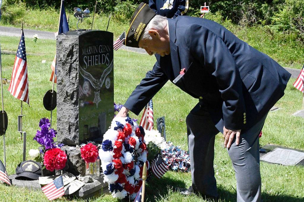 Junior Vice Cmdr. Joe Borden of VFW Post 6768 in Carlsborg lays a wreath at the headstone of Medal of Honor recipient U.S. Navy Seabee Marvin G. Shields during Memorial Day ceremonies Monday at the Gardiner Cemetery. (Jeannie McMacken/Peninsula Daily News)
