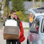 Port Angeles High School NJROTC cadet Harrison Fulton assists with collecting material to be shredded during a recent fundraiser.