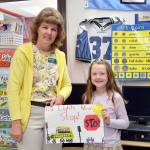 Franklin Elementary School first grader Veronica Schaefermeyer and her first place poster, shown with Karen Ross, Port Angeles School District transportation director. (Patsene Dashiell/Port Angeles School District)
