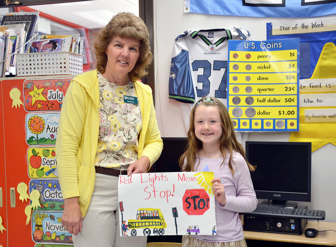 Franklin Elementary School first grader Veronica Schaefermeyer and her first place poster, shown with Karen Ross, Port Angeles School District transportation director. (Patsene Dashiell/Port Angeles School District)