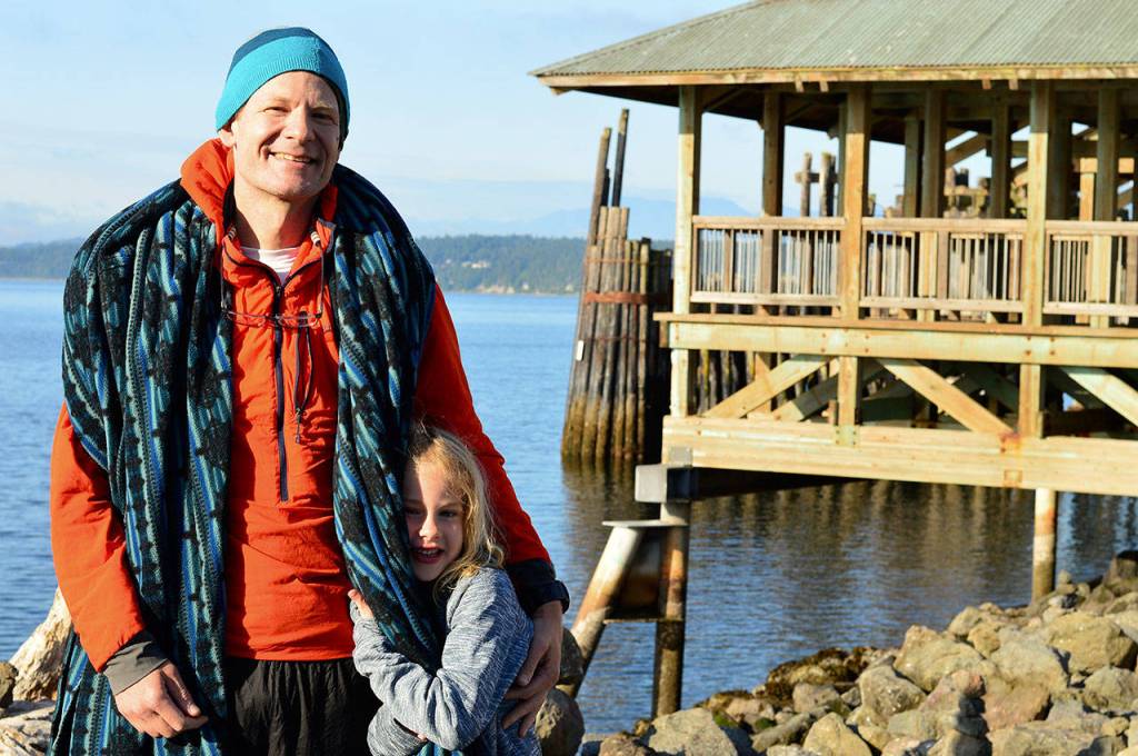 Ken Deem, the first solo finisher in the Seventy48 race, rowed in to meet his daughter Penelope, 6, at two minutes before 6 oclock Saturday morning. (Diane Urbani de la Paz/for Peninsula Daily News)