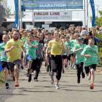 Photos by <strong>Keith Thorpe</strong>/Peninsula Daily News                                Youngsters accompanied by a pair of pace runners take off down the Waterfront Trail portion of the Olympic Discovery Trail from Port Angeles City Pier during Saturdays Kids Marathon, a kickoff event to todays Olympic Discovery Marathon. An estimated 400 children, along with parents and other adults, took part in the 1.2-mile fun run.