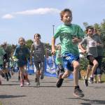 Keith Thorpe/Peninsula Daily News A group of children race down the Waterfront Trail during Saturdays Kids Marathon.