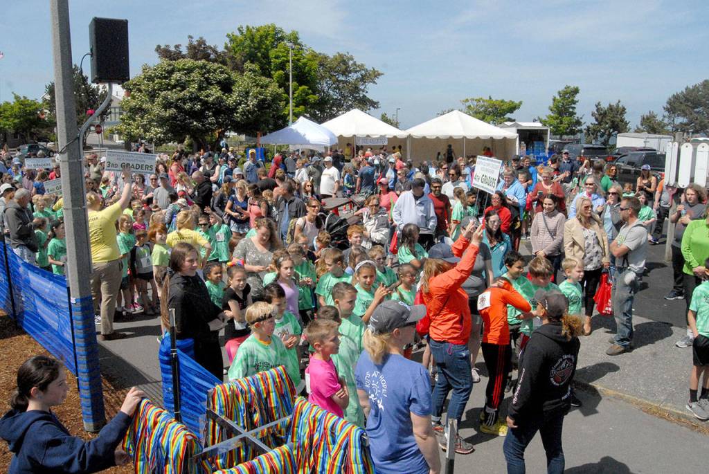 Keith Thorpe/Peninsula Daily News Children and their parents gather around the park at City Pier at the start of Saturdays Kids Marathon.