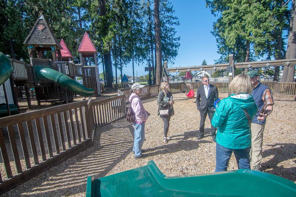 Officials with the city of Port Angeles and Dream Playground Foundation walk through the Dream Playground as they discuss the design for the new park with Play By Design Project Manager Laura Sehn. (Jesse Major/Peninsula Daily News)