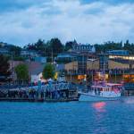 People gather along the shore outside the Northwest Maritime Center in Port Townsend to watch the start of the Race to Alaska on Monday morning. (Jesse Major/Peninsula Daily News)