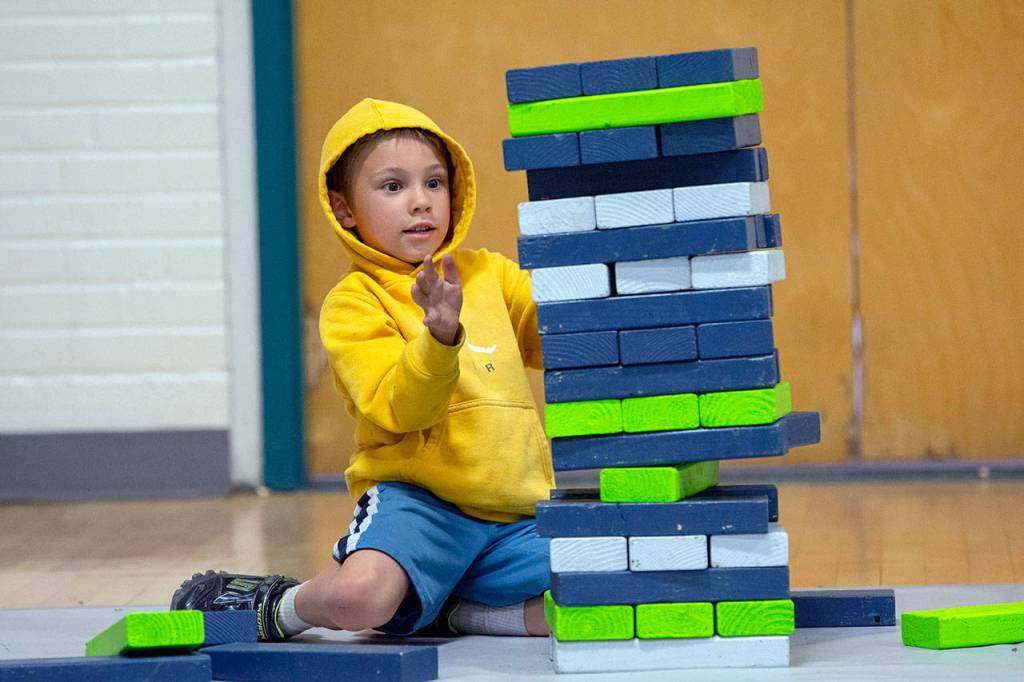 Braden Gray, 5, realizes the stack of blocks he had been playing with are about to fall during the reveal of the Generation II Dream Playground. (Jesse Major/Peninsula Daily News)
