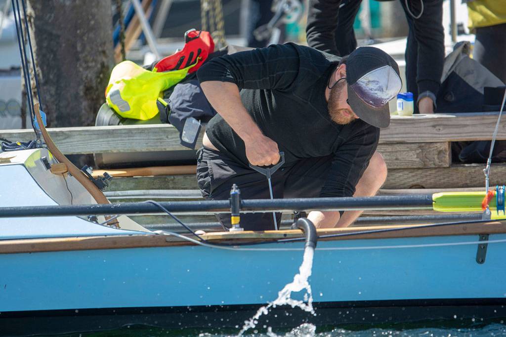 Trevor Bennett of Team Wee Free Men prepares for the Race to Alaska in Victoria on Thursday. (Jesse Major/Peninsula Daily News)