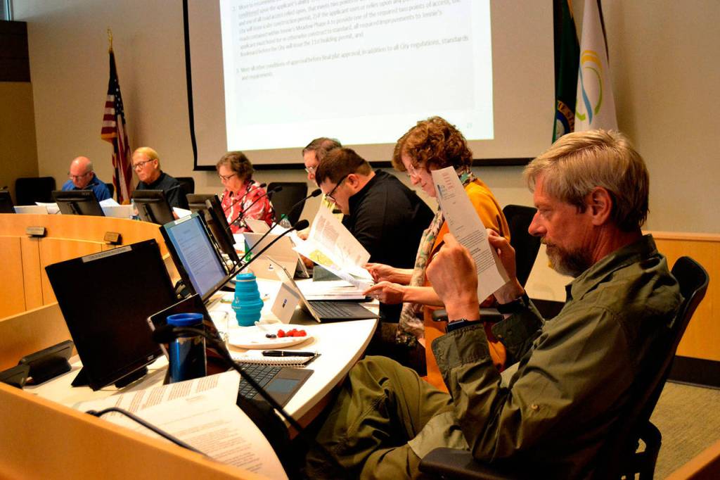 Sequim City Council members read documents that were submitted just prior and at the May 28 meeting during a 15-minute recess. They later unanimously approved a 71-lot addition to Jennies Meadow but denied a variance to use the existing road as-is on Jennies Meadow Lane. (Matthew Nash/Olympic Peninsula News Group)