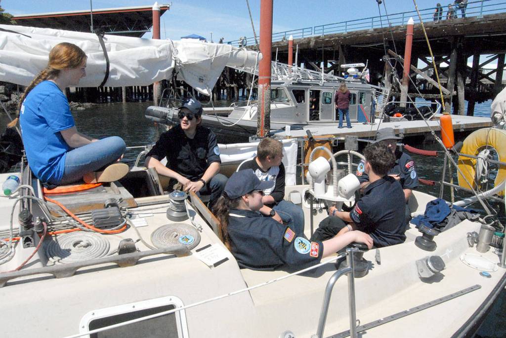 The SSS Marvin Shields crew of the Sea Scouts program of Boys Scouts of America sit aboard the sailboat Knight n Gale at Port Angeles City Pier on Saturday. (Keith Thorpe/Peninsula Daily News)