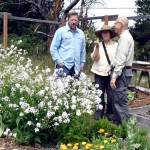 State Rep. Mike Chapman, left, visited the garden at the Quimper Grange on 1219 Corona St., on Wednesday as part of a tour of gardens that supply area food banks. He was joined by Kathy Ryan, president of Jefferson County Food Bank Gardens, and Francesco Tortorici of Olympic BioChar. (Jeannie McMacken/Peninsula Daily News)