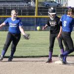 <strong>Dave Logan</strong>/for Peninsula Daily News                                Boulevard Wellness Malena Marquez stands up safely after stealing second base while Olympic Labor Councils Violet Mills (5) and her teammate Evie Seeyle attempt to field the ball.